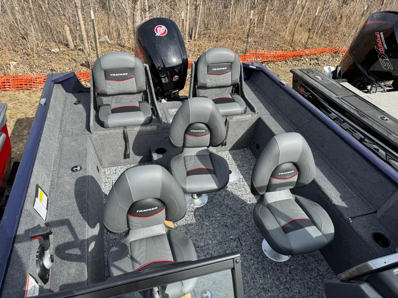 Slide: The Image of 2025 Tracker Pro Guide V-175 Combo boat interior with six gray seats and motor. - 6