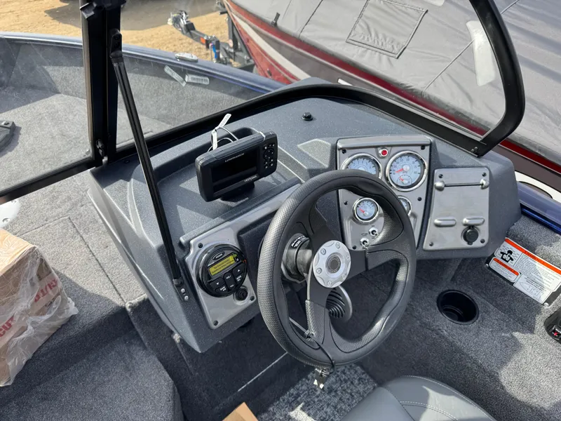Slide: The Image of 2025 Tracker Pro Guide V-175 Combo boat dashboard with steering wheel and gauges. - 9