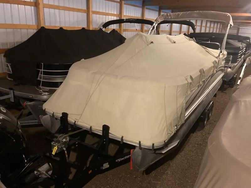 Slide: The Image of 2003 Bennington 2275RL pontoon boat covered in storage. - 1