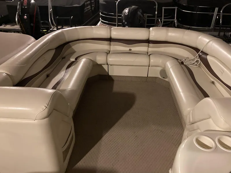 Slide: The Image of 2003 Bennington 2275RL pontoon boat interior with beige seating and cup holders. - 13