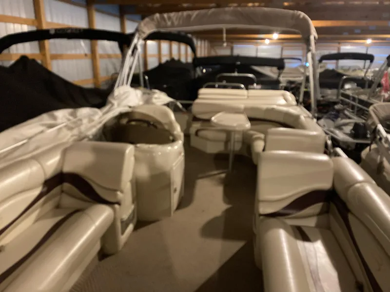 Slide: The Image of 2003 Bennington 2275RL pontoon boat with spacious seating in a storage facility. - 15