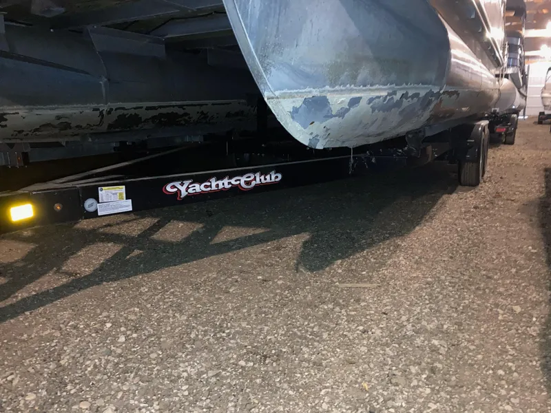 Slide: The Image of 2003 Bennington 2275RL pontoon on Yacht Club trailer, parked on gravel surface. - 16
