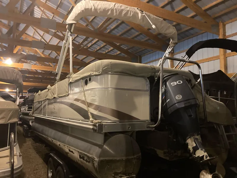Slide: The Image of 2003 Bennington 2275RL pontoon boat with canopy, stored indoors. - 2