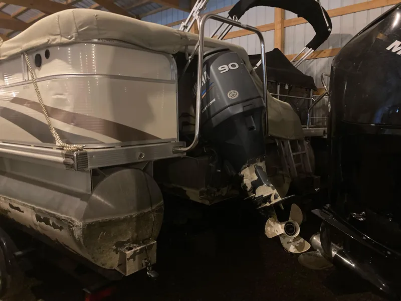 Slide: The Image of 2003 Bennington 2275RL pontoon boat with 90 HP outboard motor in storage. - 5