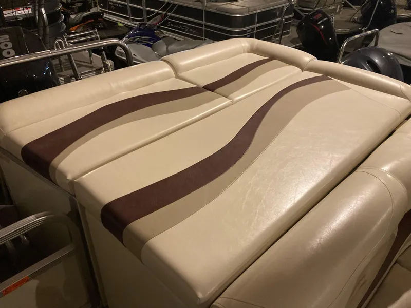 Slide: The Image of Beige and brown cushioned seating on a 2003 Bennington 2275RL boat. - 9