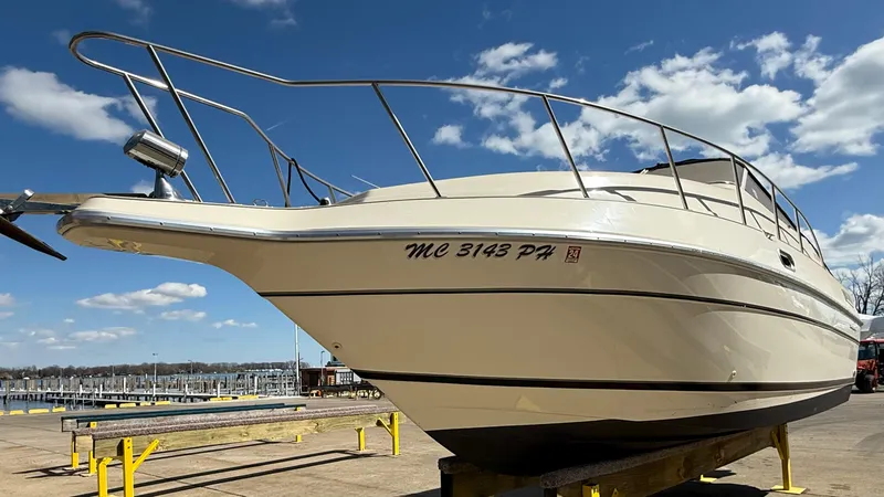 Slide: The Image of 1992 Century Antigua 235 boat on dry dock under a clear blue sky. - 0