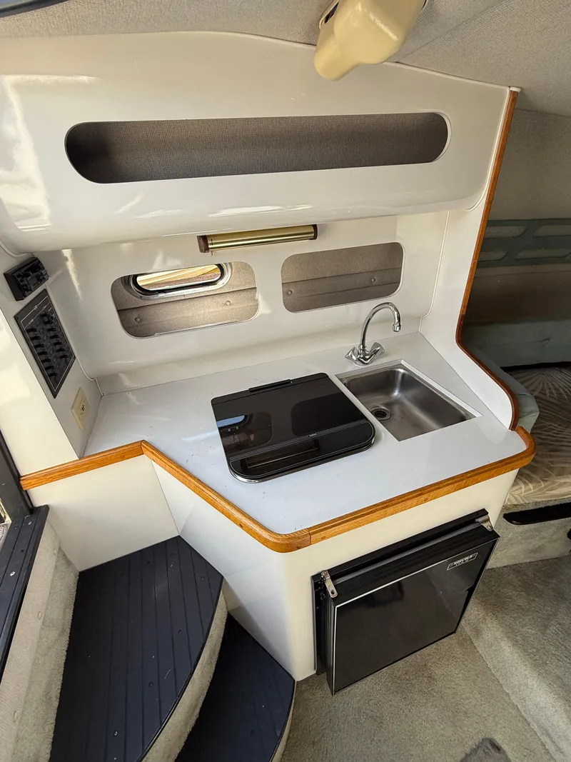Slide: The Image of 1992 Century Antigua 235 boat interior with compact kitchen, sink, and stove. - 15