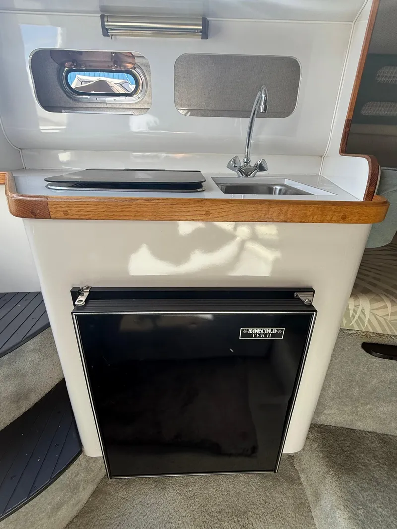 Slide: The Image of 1992 Century Antigua 235 boat interior with sink and mini fridge. - 16
