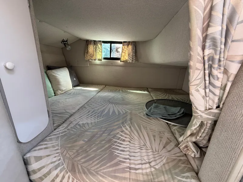 Slide: The Image of Cozy cabin interior of 1992 Century Antigua 235 boat with patterned bedding and small window. - 18