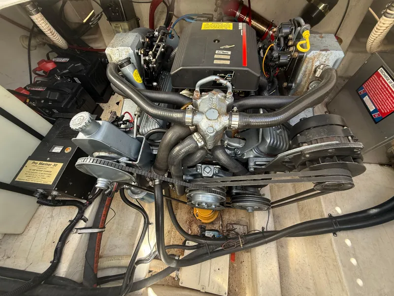Slide: The Image of Engine compartment of a 1992 Century Antigua 235 boat, showcasing mechanical components and wiring. - 19