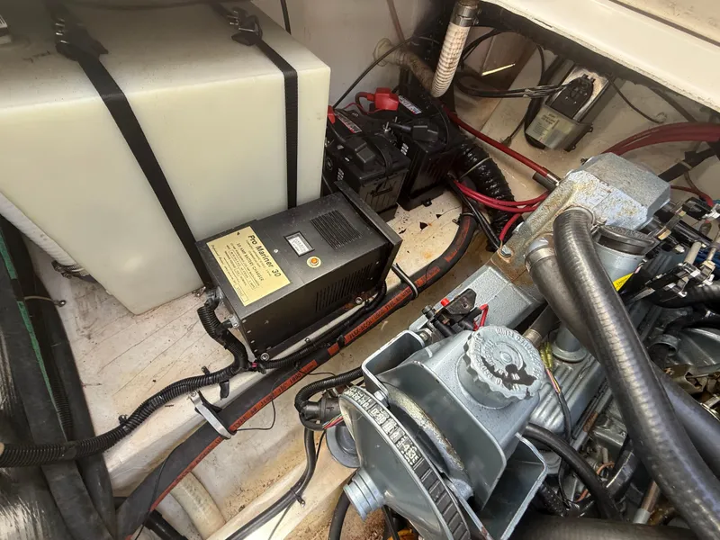 Slide: The Image of Engine compartment of a 1992 Century Antigua 235 boat, showing battery and wiring. - 20