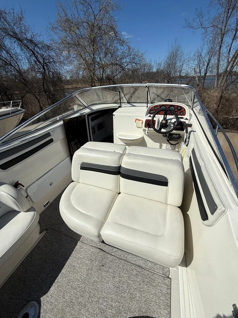 Slide: The Image of 1992 Century Antigua 235 boat interior with white seating and steering wheel. - 6
