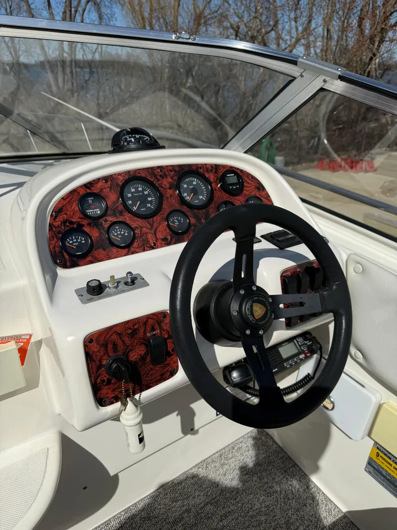 Slide: The Image of 1992 Century Antigua 235 boat dashboard with steering wheel and gauges. - 9