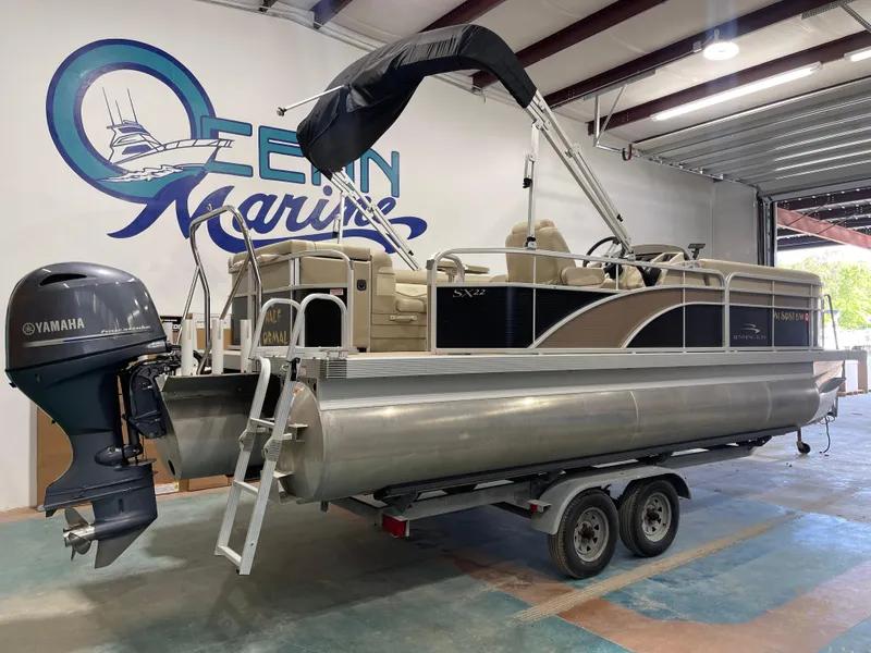 Slide: The Image of 2016 Bennington 22SX pontoon boat with Yamaha engine in a marine showroom. - 11