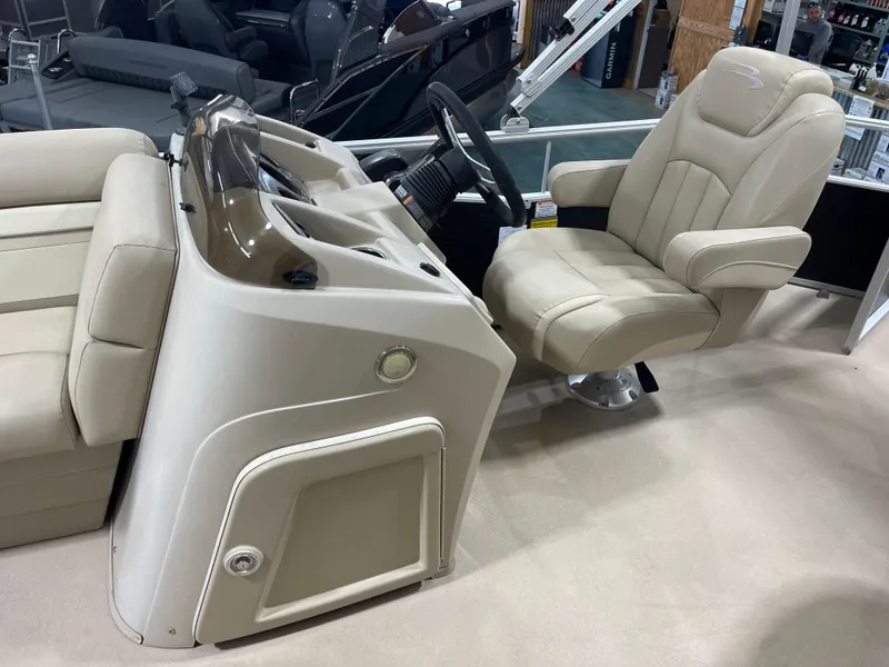 Slide: The Image of 2016 Bennington 22SX boat interior with beige captain's chair and control console. - 14