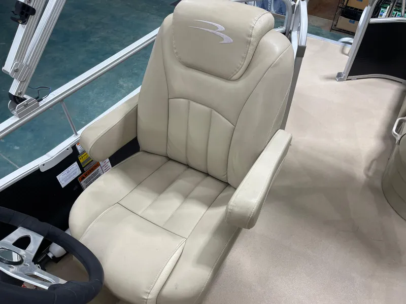 Slide: The Image of Captain's chair on 2016 Bennington 22SX boat, featuring beige upholstery and armrests. - 15