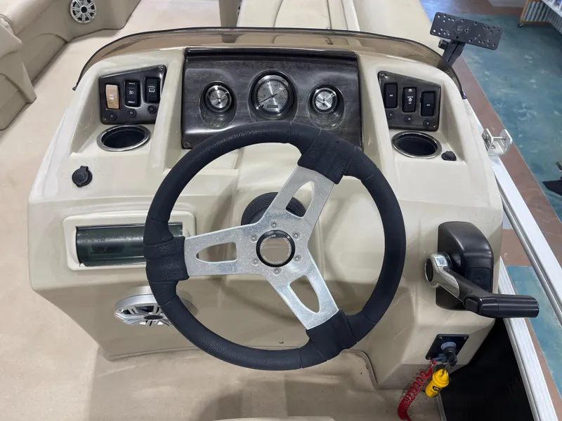Slide: The Image of Steering console of a 2016 Bennington 22SX boat with gauges and controls. - 16