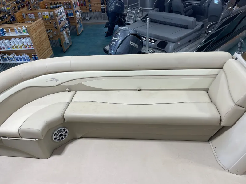 Slide: The Image of 2016 Bennington 22SX boat interior with beige seating and Yamaha outboard motor. - 19