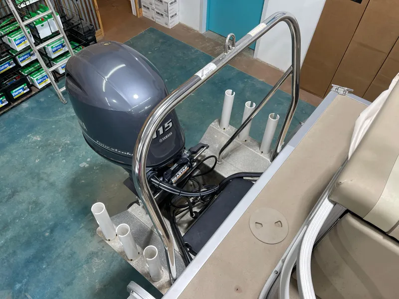 Slide: The Image of 2016 Bennington 22SX boat with Yamaha 115 outboard motor in a storage area. - 23