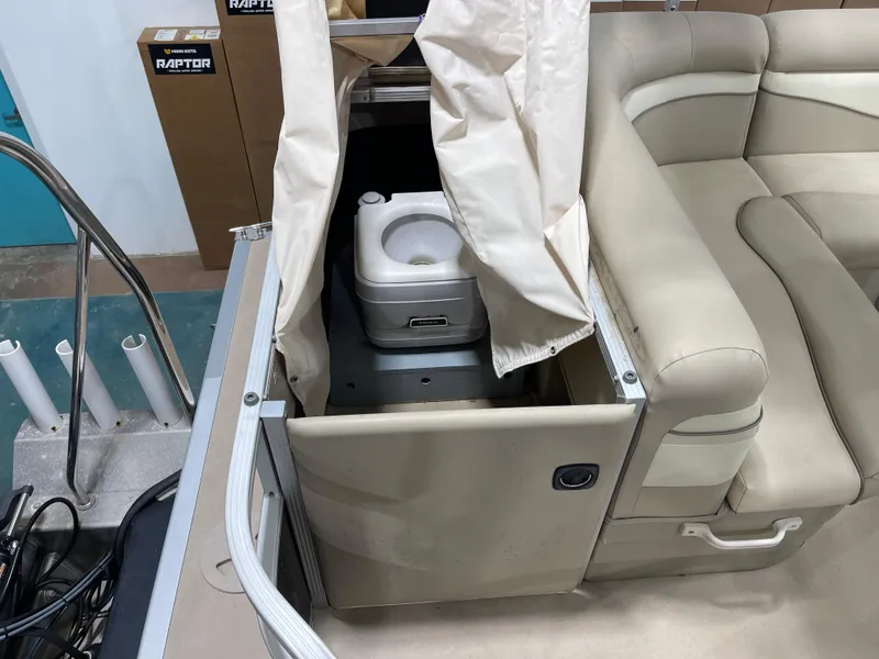Slide: The Image of 2016 Bennington 22SX boat with portable toilet and beige seating. - 24