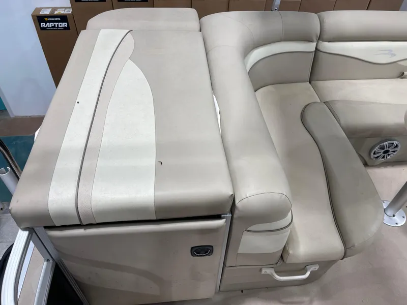 Slide: The Image of 2016 Bennington 22SX boat interior with beige cushioned seating and speaker. - 25