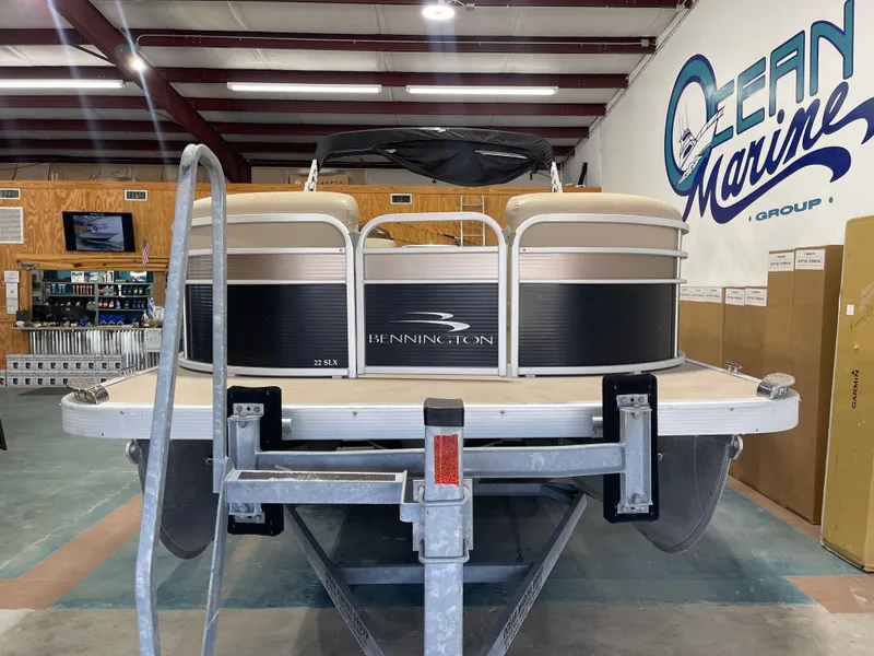 Slide: The Image of 2016 Bennington 22SX pontoon boat on trailer in showroom. - 5