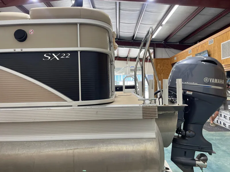 Slide: The Image of 2016 Bennington 22SX pontoon boat with Yamaha outboard motor in a showroom. - 7