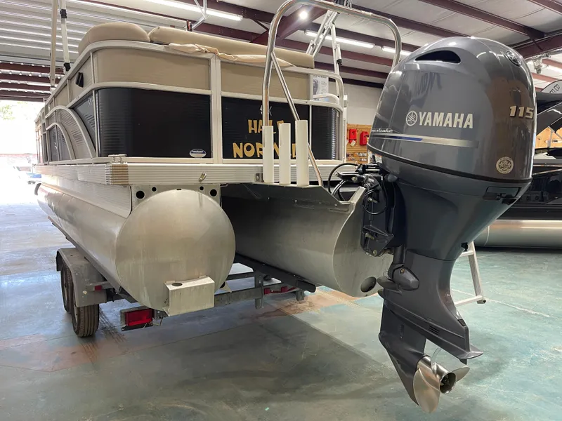 Slide: The Image of 2016 Bennington 22SX pontoon boat with Yamaha 115 outboard motor in a garage. - 8