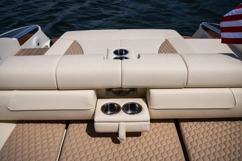 Slide: The Image of 2024 Chris-Craft Launch 35 GT boat interior with beige seating and cup holders. - 19
