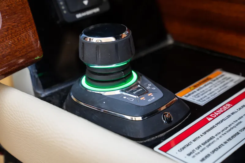 Slide: The Image of 2024 Chris-Craft Launch 35 GT joystick control with illuminated green ring and warning labels. - 27