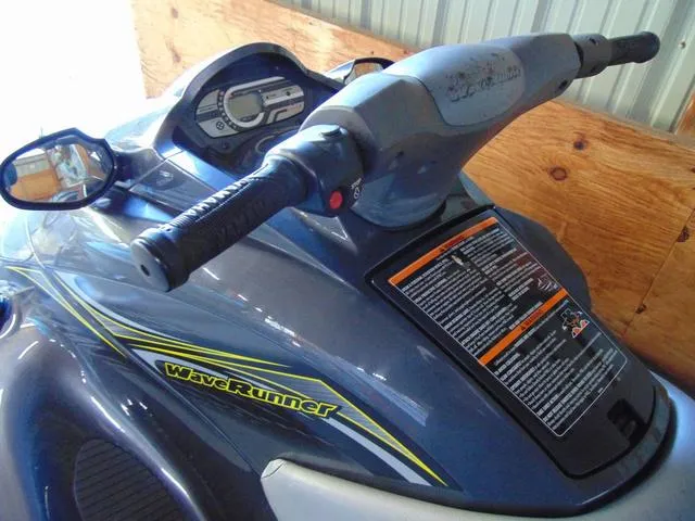 Slide: The Image of 2014 Yamaha WaveRunner VX jet ski with handlebars and dashboard in a storage area. - 3