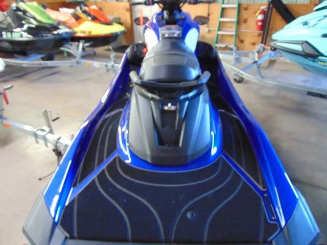 Slide: The Image of 2024 Yamaha Waverunner GP SVHO with Audio, blue, in a showroom with other watercraft. - 7