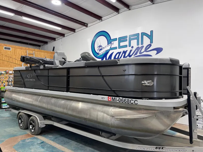 Slide: The Image of 2021 Veranda VR22RC pontoon boat displayed indoors at Ocean Marine dealership. - 1