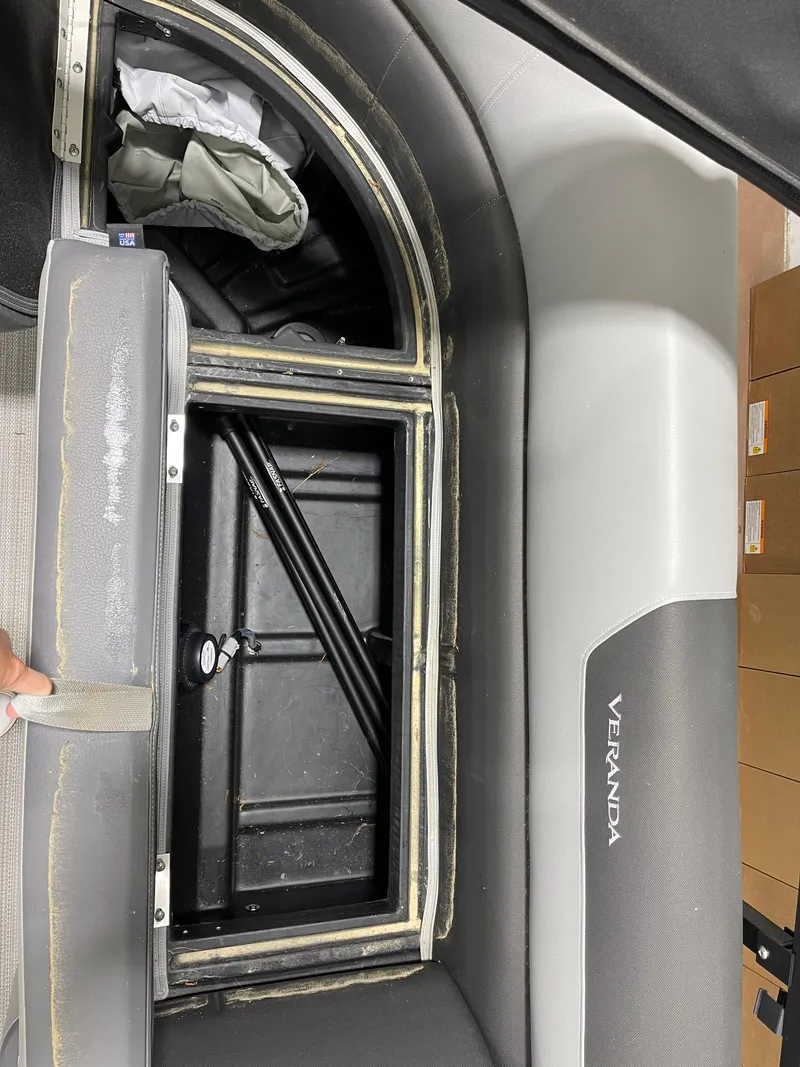 Slide: The Image of 2021 Veranda VR22RC boat storage compartment with open lid, revealing interior details. - 19