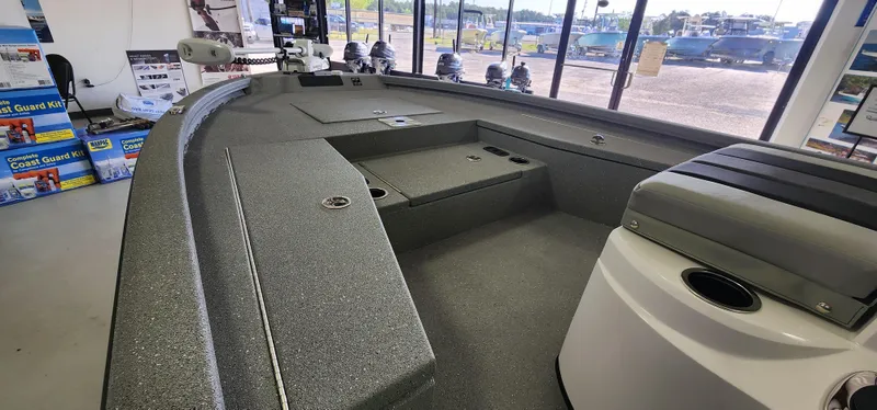 Slide: The Image of 2025 Vexus ACX2000 boat interior with spacious deck and seating in showroom. - 10