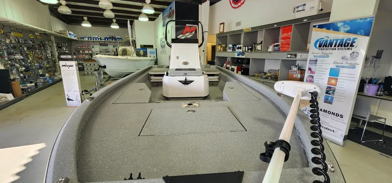 Slide: The Image of 2025 Vexus ACX2000 boat displayed in a showroom with various boating accessories. - 12