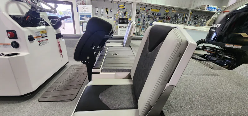 Slide: The Image of 2025 Vexus ACX2000 boat interior with seating and control panel in showroom. - 13