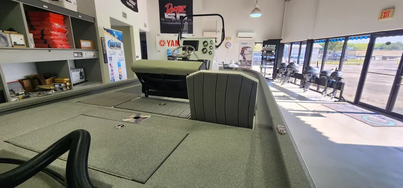 Slide: The Image of 2025 Vexus ACX2000 boat interior in showroom with equipment and accessories displayed. - 6