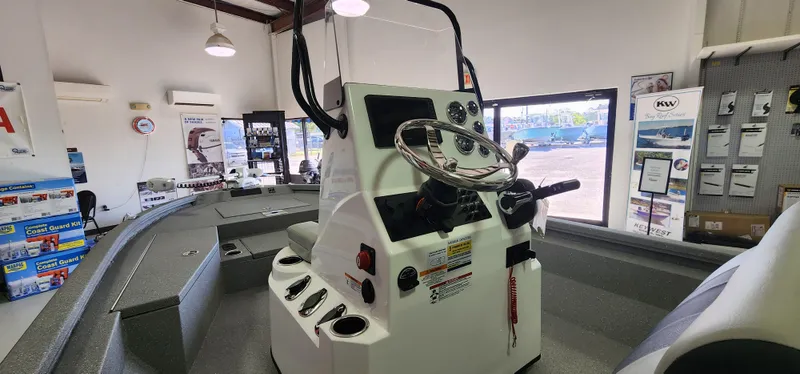 Slide: The Image of 2025 Vexus ACX2000 boat interior with steering console in showroom. - 8