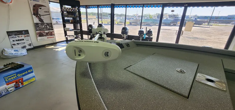 Slide: The Image of 2025 Vexus ACX2000 boat interior with Minn Kota trolling motor in showroom. - 11