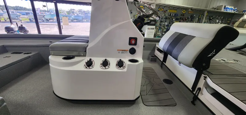 Slide: The Image of 2025 Vexus ACX2000 boat interior with seating and control panel in showroom. - 9