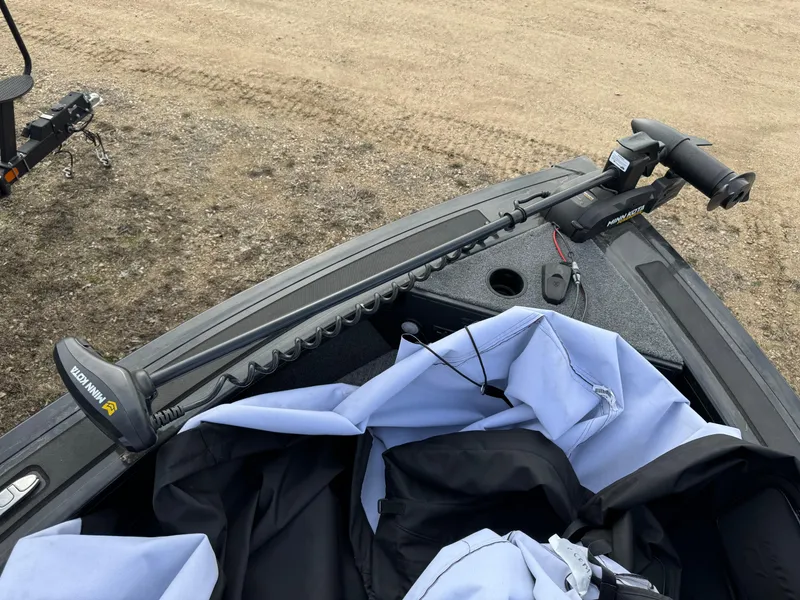 Slide: The Image of 2023 Tracker Targa V-19 WT boat with trolling motor and cover on a sandy surface. - 5