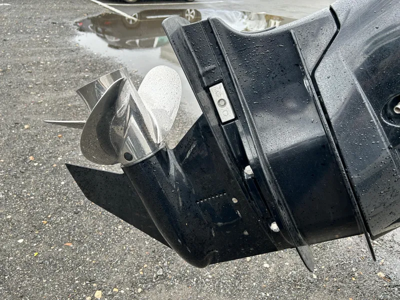 Slide: The Image of Close-up of a 2015 Boston Whaler 190 Montauk boat propeller on wet pavement. - 10