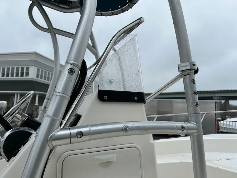 Slide: The Image of 2015 Boston Whaler 190 Montauk boat detail with metal railing and console. - 11