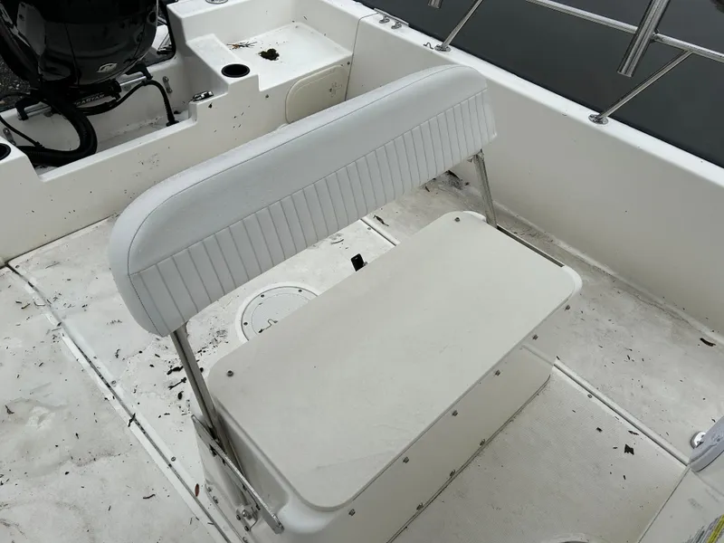 Slide: The Image of 2015 Boston Whaler 190 Montauk boat interior with white seating and clean deck. - 12