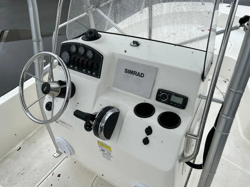 Slide: The Image of 2015 Boston Whaler 190 Montauk boat console with steering wheel and Simrad electronics. - 14