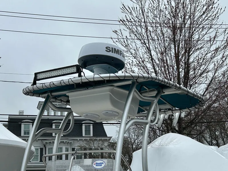 Slide: The Image of Boston Whaler 190 Montauk 2015 boat with radar and T-top, parked outdoors. - 3