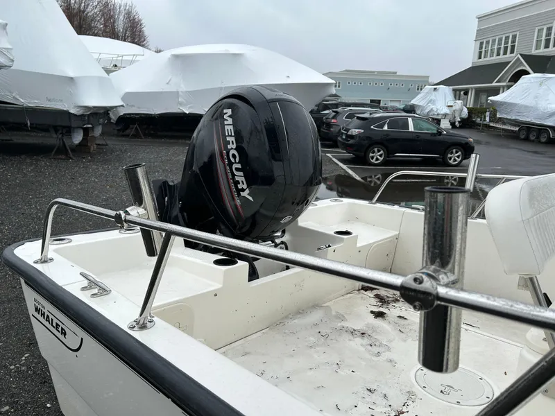 Slide: The Image of 2015 Boston Whaler 190 Montauk with Mercury engine in a boatyard setting. - 9