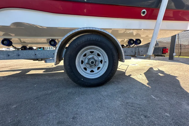 Slide: The Image of 2014 NauticStar 203DC Sport Deck on trailer, close-up of wheel and hull. - 10