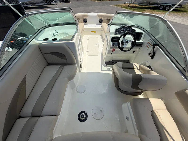 Slide: The Image of 2014 NauticStar 203DC Sport Deck boat interior with seating and steering console. - 13